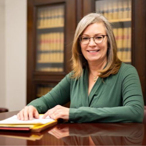 Attorney Kate Cerrone seated at conference table at The Northeast Law Center in Putnam, CT.